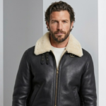 man wearing phantom b3 bomber sheearling leather jacket against a grayish bakcground
