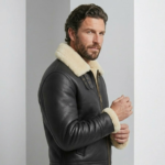 man wearing phantom b3 bomber sheearling leather jacket against a grayish bakcground 2