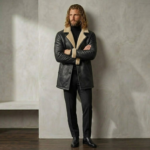 Man wearing Midnight men's black shearling coat from snag leather hands crossed