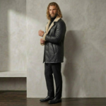 Man wearing Midnight men's black shearling coat from snag leather side pose